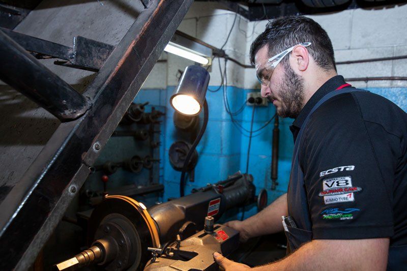 A Man Repairing The Disk Break - Adelaide, SA - Silver’s Auto Centre