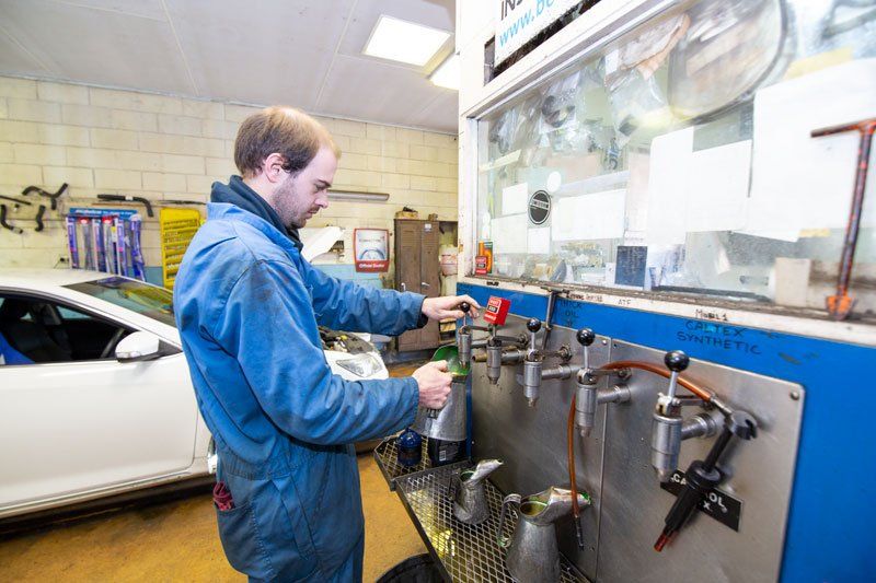 A Man Getting An Engine Oil - Adelaide, SA - Silver’s Auto Centre