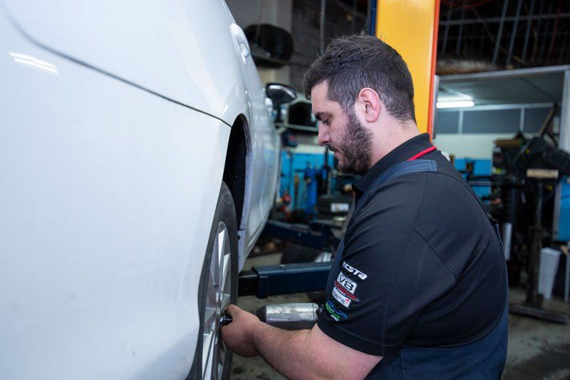 A Man Removing The Bolt Of The Wheel - Adelaide, SA - Silver’s Auto Centre