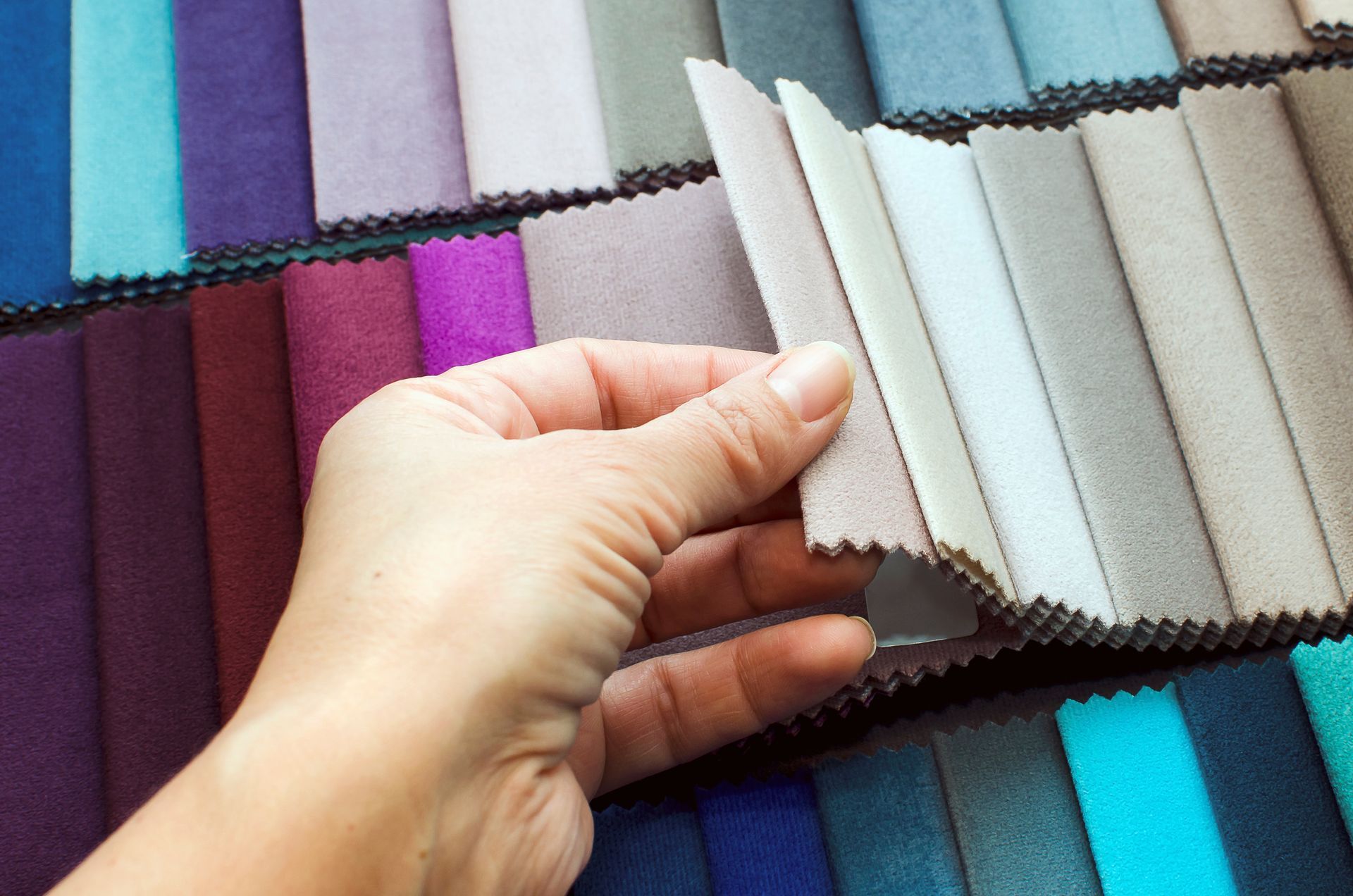 Hand selecting fabric swatches for custom-design upholstery in a wide range of premium colors.