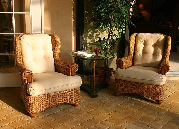 Two outdoor wicker chairs in the late afternoon sunset