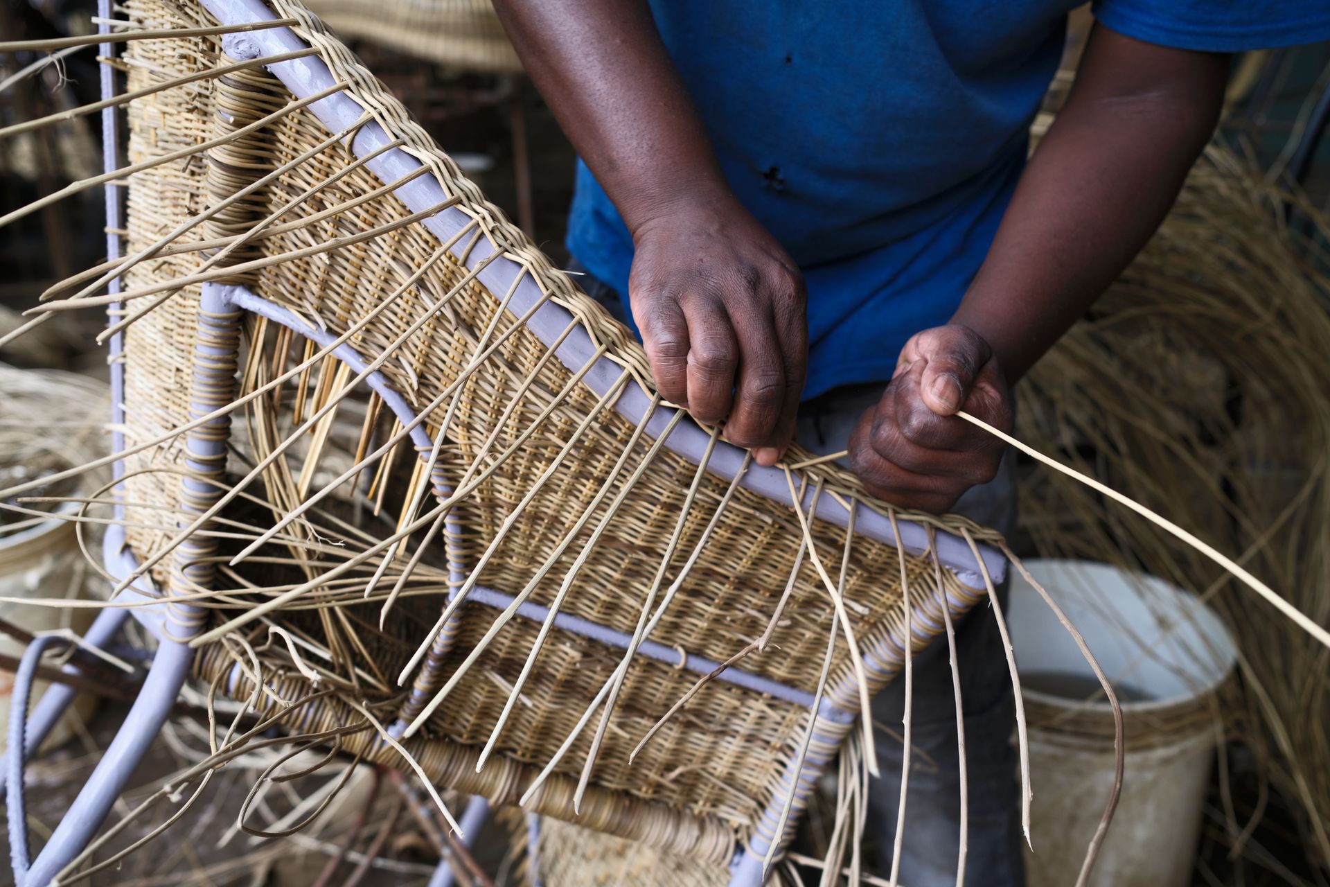Artisan hands crafting traditional wicker furniture.