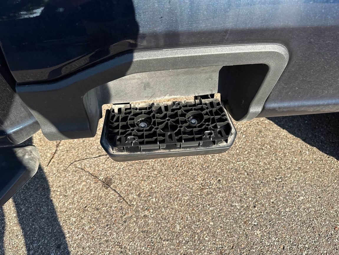 Black pickup truck side step, the step's center is missing.