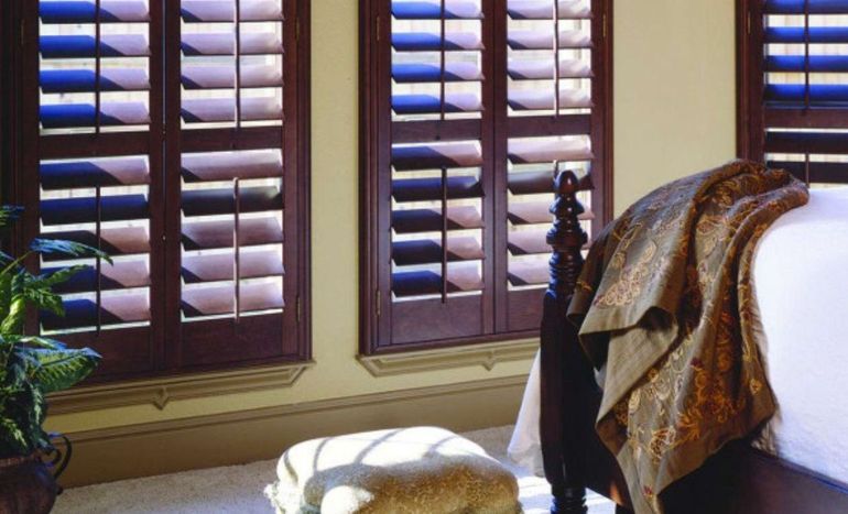 Classic wooden shutters with concealed tilt rods for a clean look.