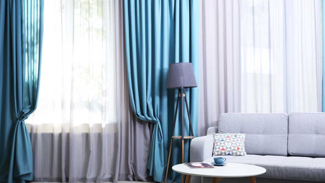 A cozy living room featuring blue curtains and a comfortable couch.