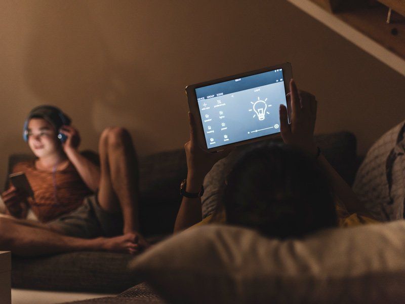 person looking at tablet in the dark