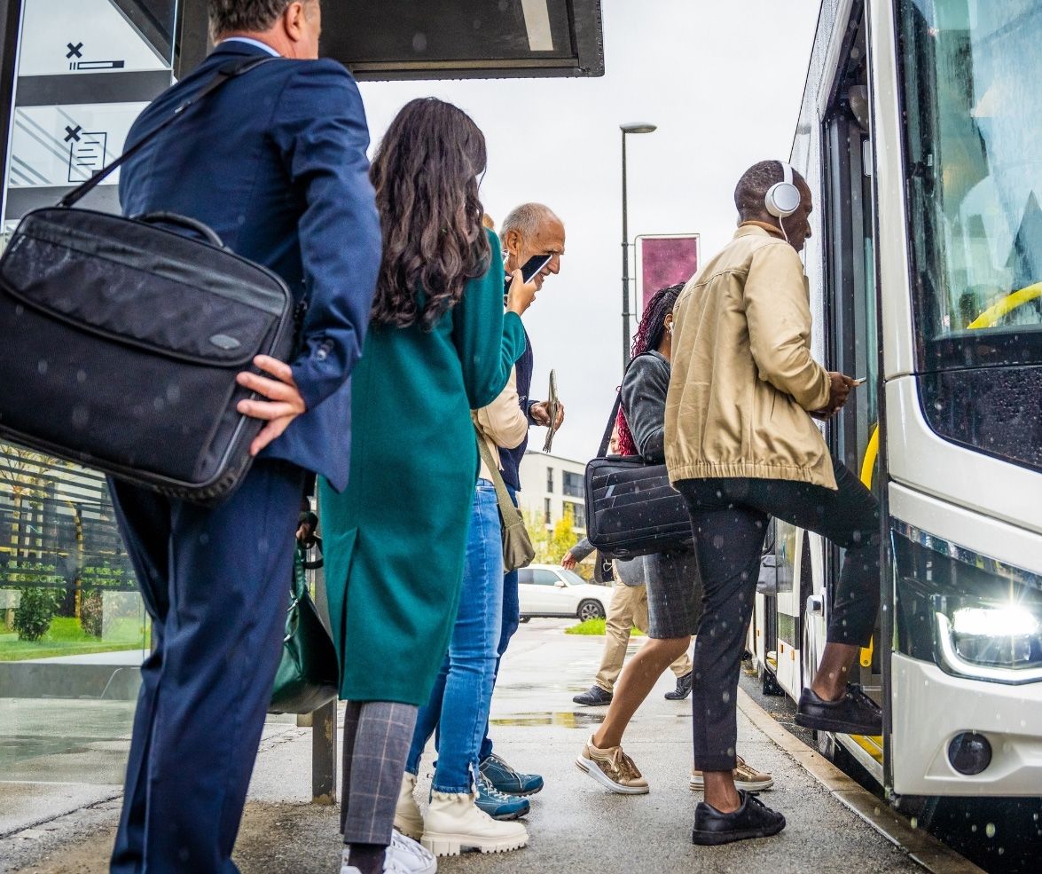 People are boarding a bus at a city stop