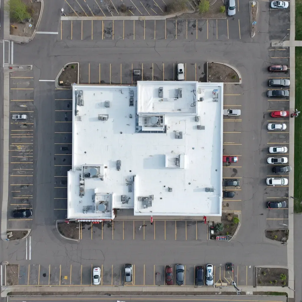 Spray-on roof sealing Joliet IL includes primer bonding, sealant application around rooftop units, and UV-stabilized finish coats for maximum durability.