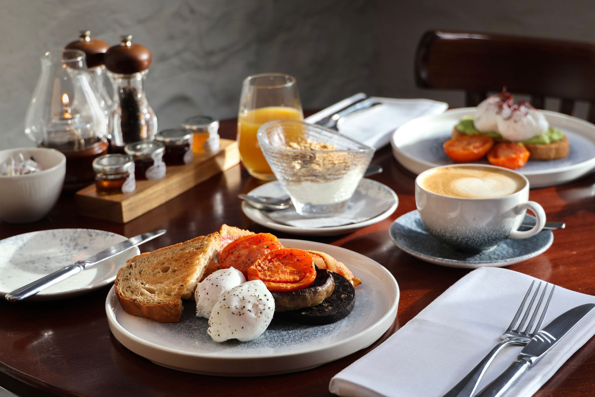 breakfast with orange juice and eggs on toast and granola and yogurt 