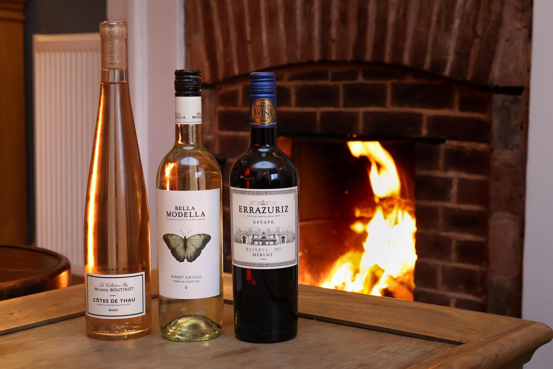 bottles of wine in front of the cosy fireplace in the south downs
