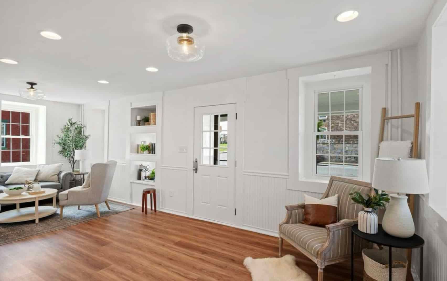 It is a living room with hardwood floors and white walls.