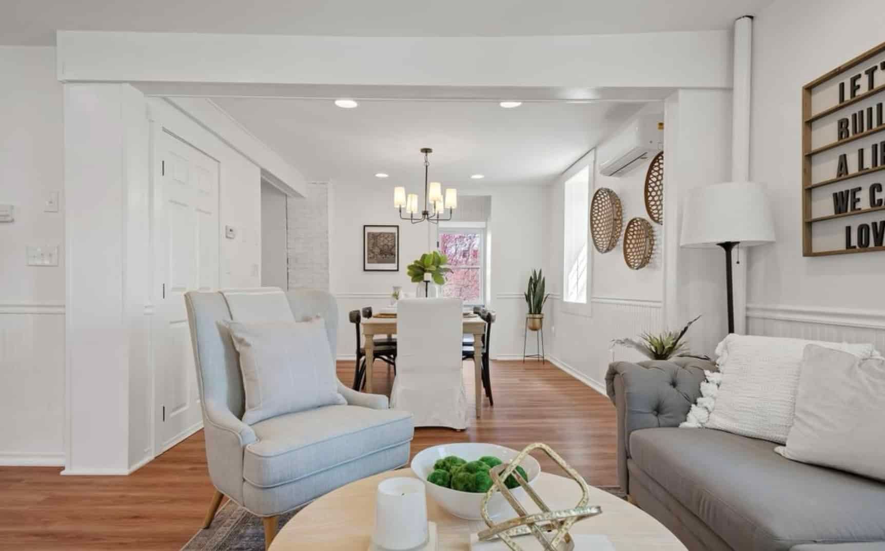 A living room with a couch , chair , and table.