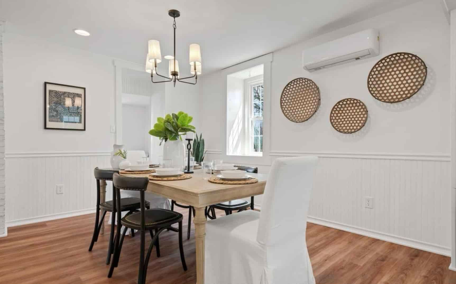 A dining room with a table and chairs and a chandelier.
