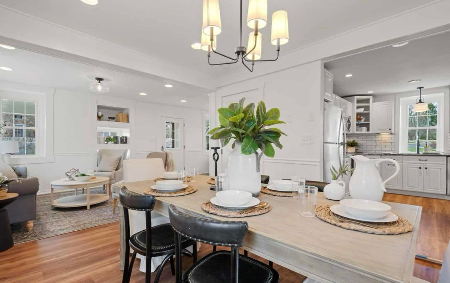 A dining room with a table and chairs and a chandelier.