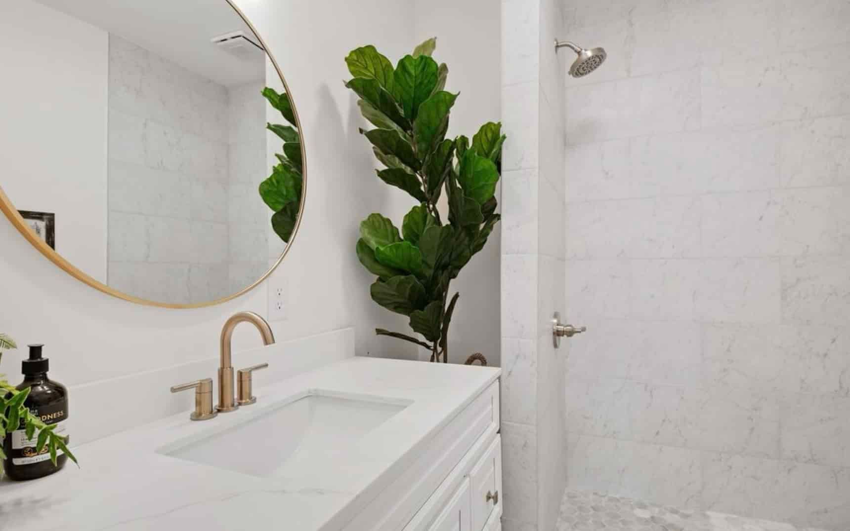 A bathroom with a sink , mirror , and shower.