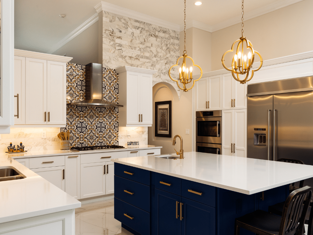 A kitchen with white cabinets , blue cabinets , stainless steel appliances , and a large island.