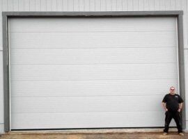 Man Standing In Front Of Garage — Garage Door in Sta Rosa, CA