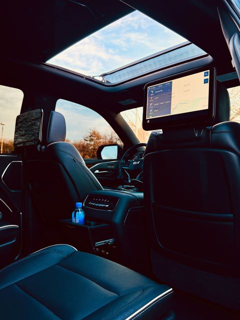 Black Luxury Sedan on suburban street at dusk