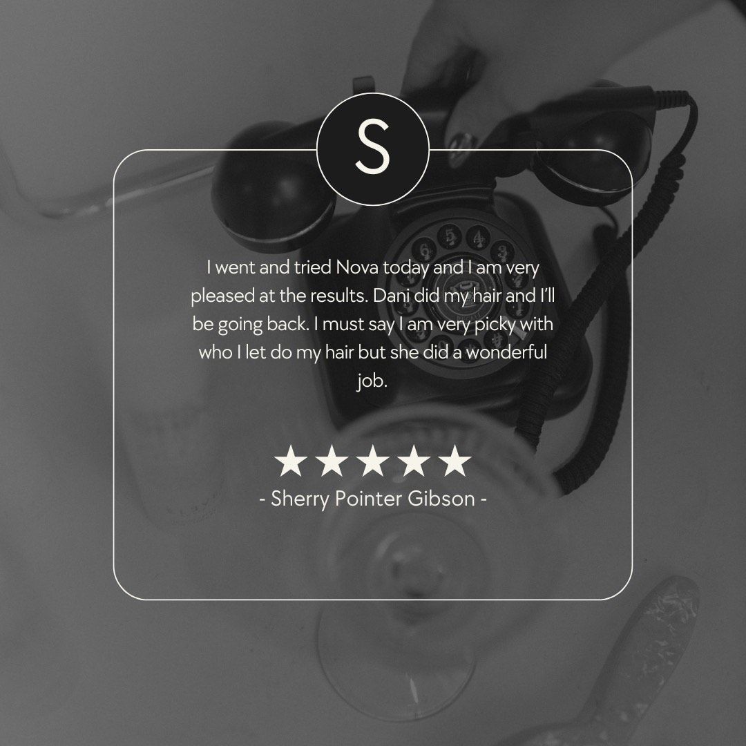 Review with text on glass in front of a vintage telephone.