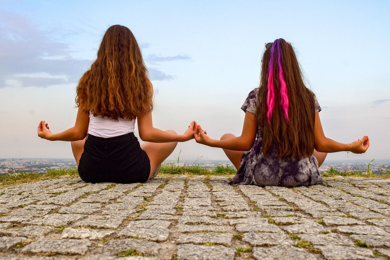 Two girls meditating