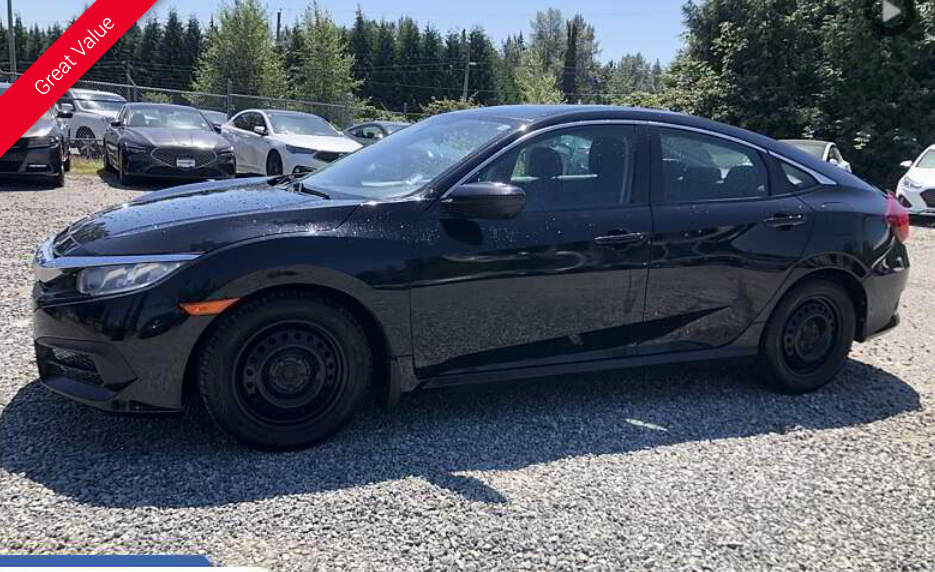 Black Honda Civic car in a parking lot on a sunny day.