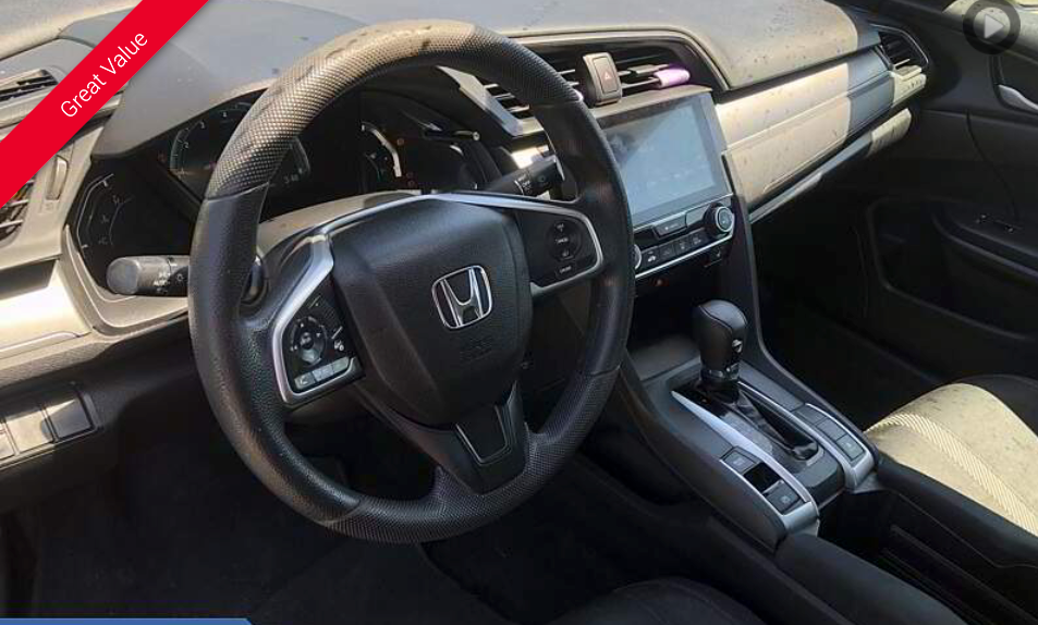 Interior view of a Honda Civic, showing the steering wheel, dashboard, and infotainment system.