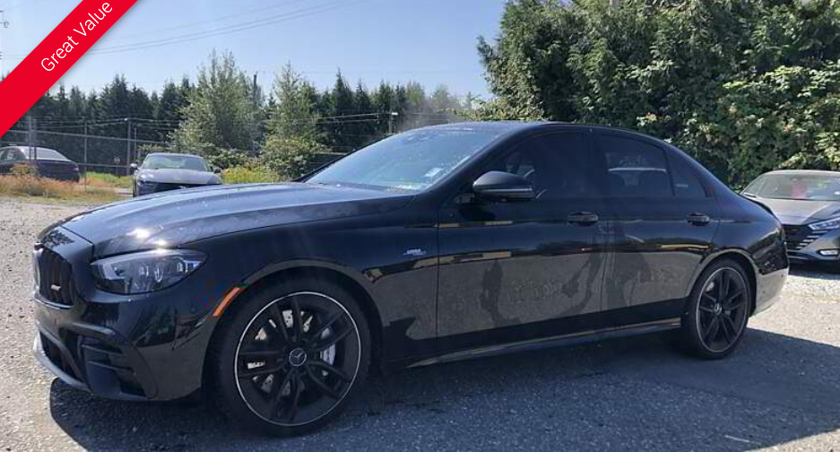 Black Mercedes-Benz sedan parked outdoors on a sunny day.