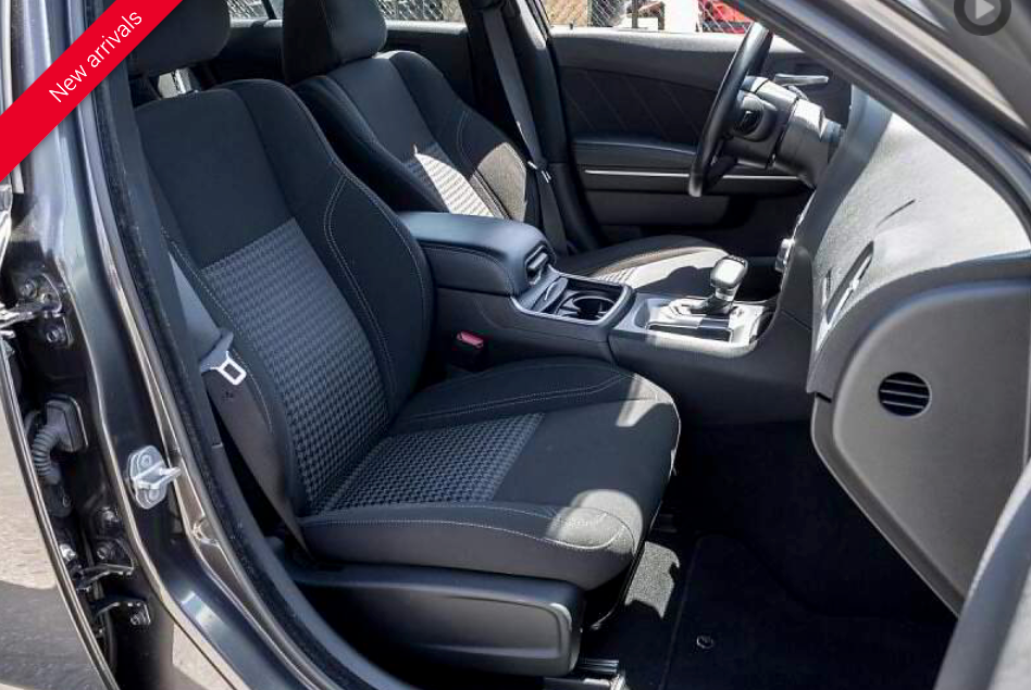 Black car interior with fabric seats, center console, and dashboard visible.