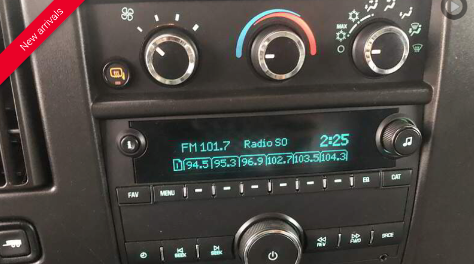 Dashboard of a vehicle with radio display, climate controls, and power button visible. The radio is tuned to FM 101.7.