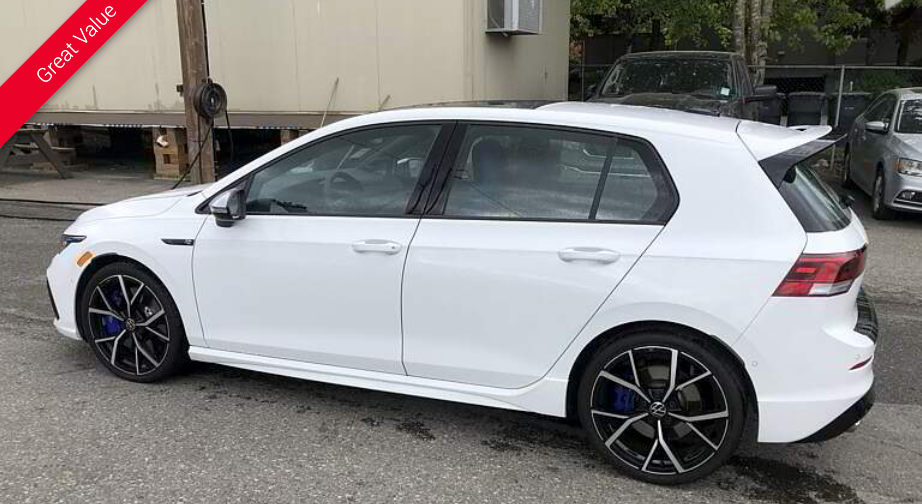 White Volkswagen Golf R parked on a street with black and blue accents.