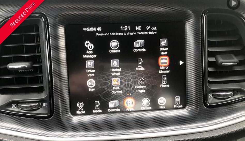 Car infotainment screen displaying menu options, with a clock display at the top and air vents on the left and right.
