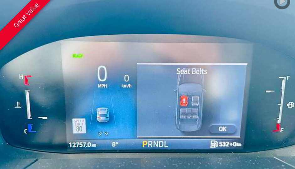 Car dashboard displaying seat belt warning with a car diagram.