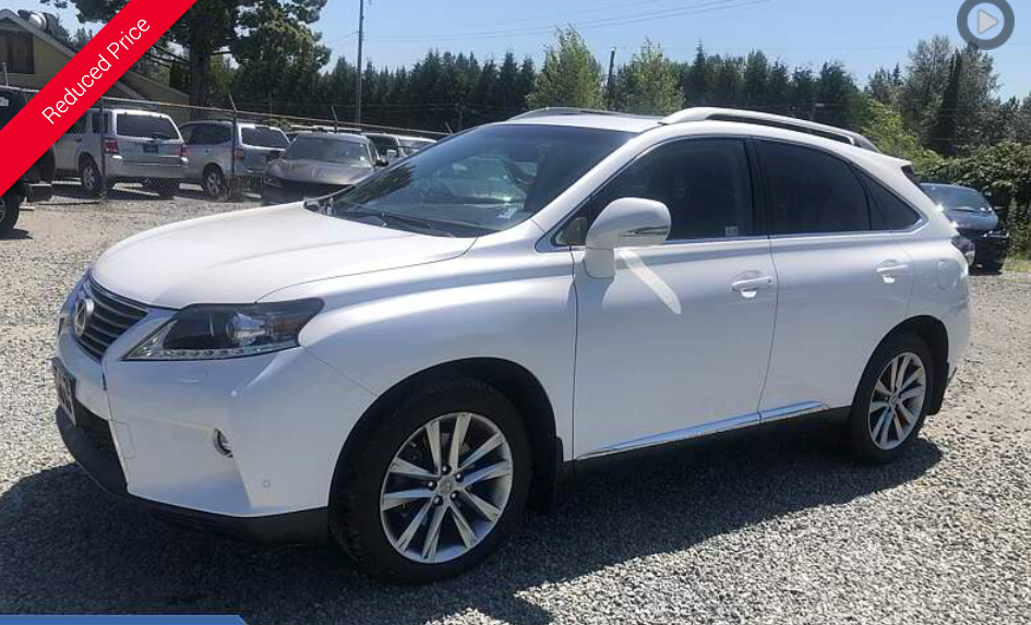 White Lexus RX SUV parked in a lot on a sunny day.