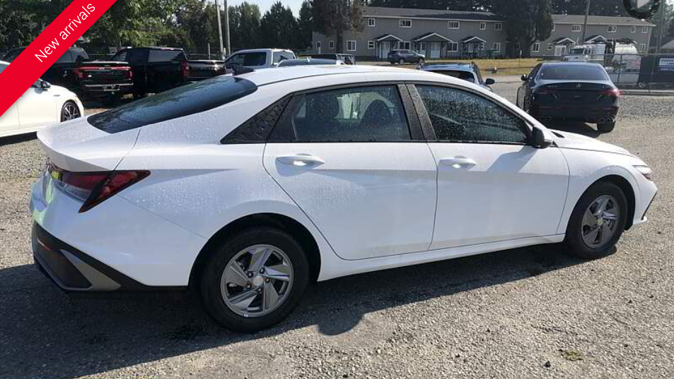 White Hyundai Elantra sedan parked outside on a sunny day.