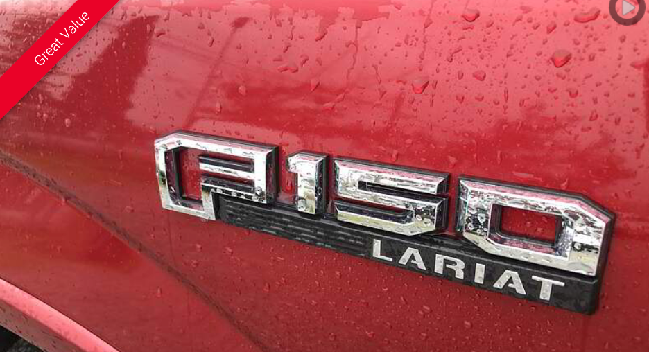 Red truck emblem: F-150 Lariat, chrome letters on a black background, with a red truck body covered in raindrops.