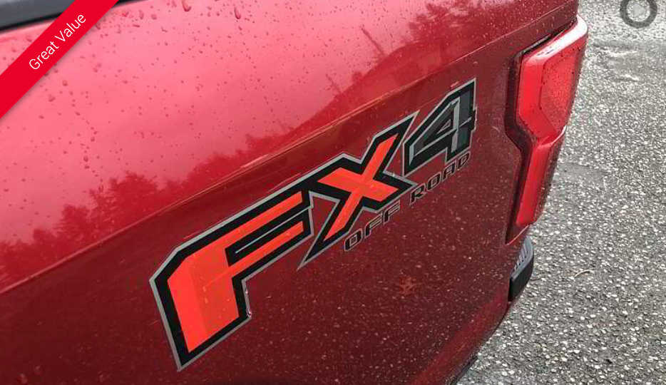 Red truck bed with FX4 Off-Road sticker; taillight visible.