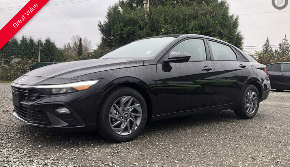 Black Hyundai sedan parked outdoors on a cloudy day.
