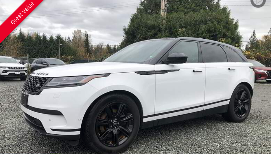 White Range Rover SUV with black trim parked outside on a cloudy day.