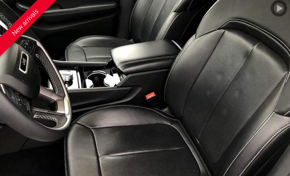 Black leather car interior with front seats, center console, and steering wheel.