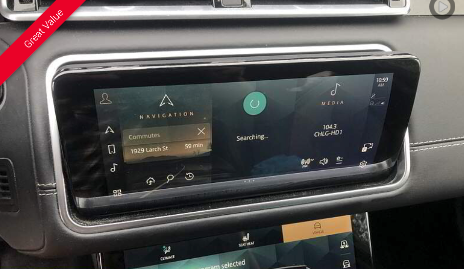 Car dashboard with two touchscreens displaying navigation and entertainment options.
