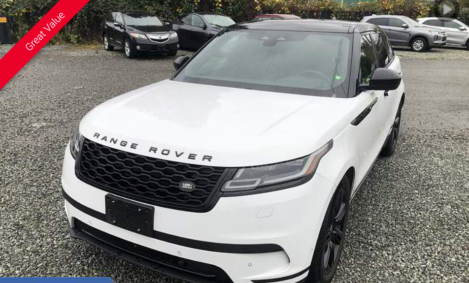 White Range Rover Velar SUV. Black roof and grille, parked outside.
