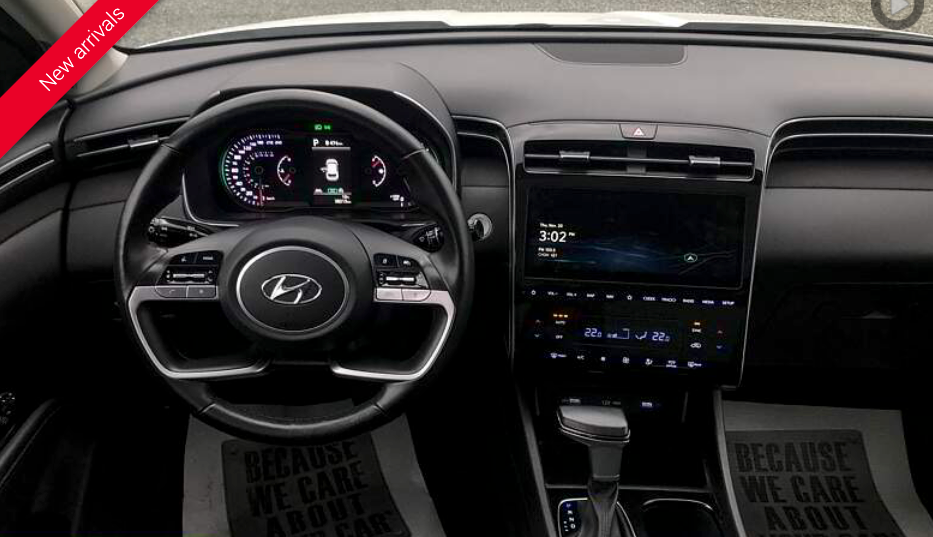 Car interior with steering wheel, digital dashboard, and infotainment screen. 