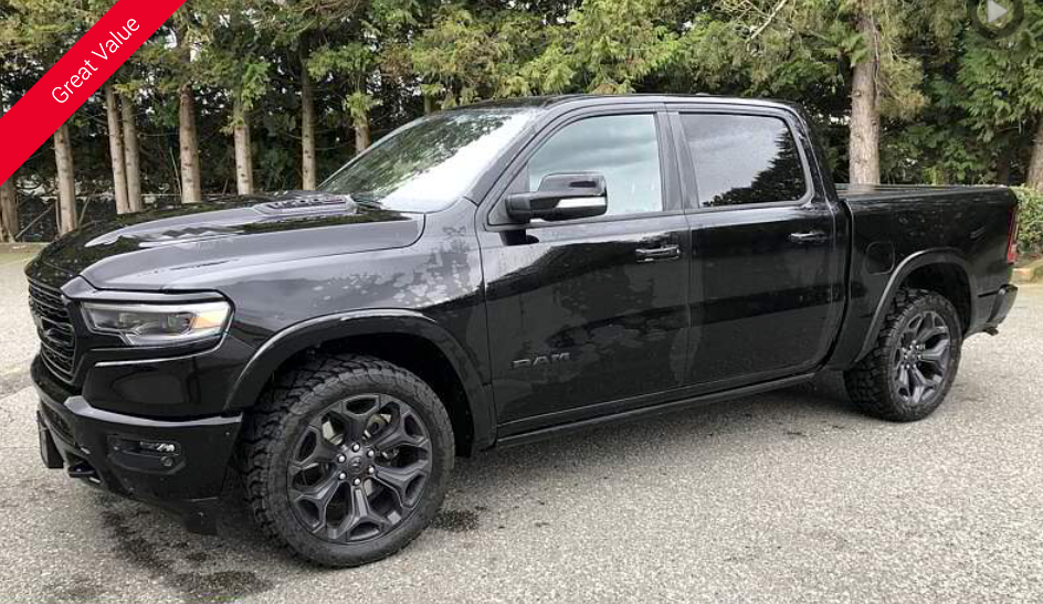 Black Ram pickup truck parked on asphalt.