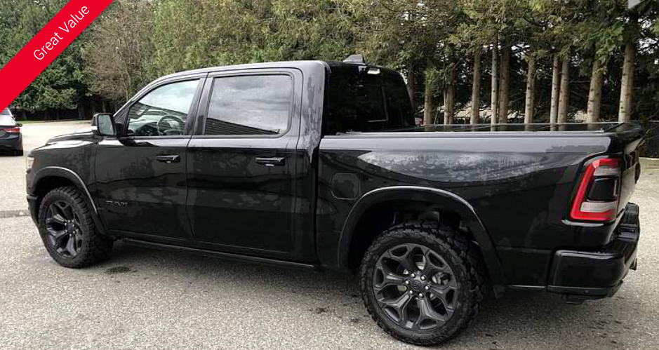 Black Ram pickup truck parked on asphalt.