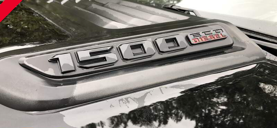 Close-up of a black truck hood with the word 
