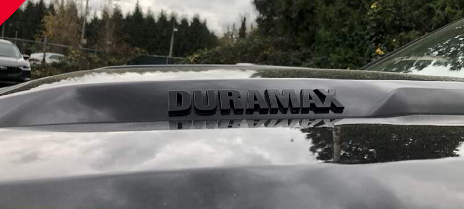 A close-up of a silver truck hood with 