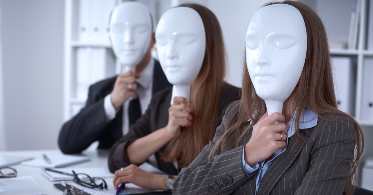 Three people in business attire holding white masks in an office setting.