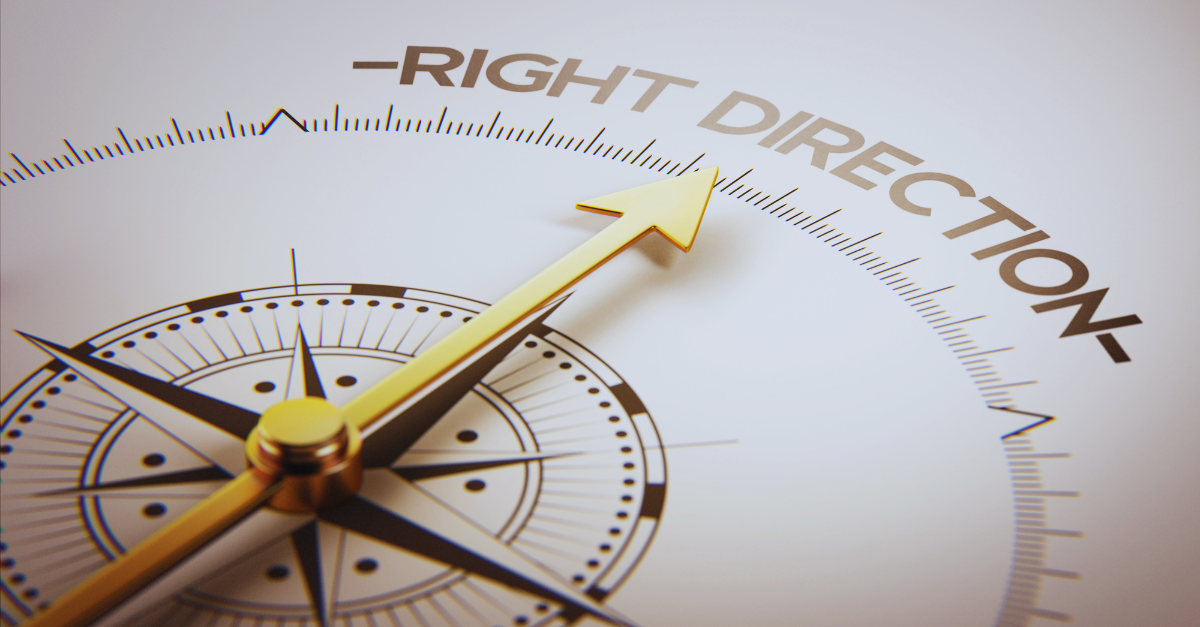 A gold compass needle points toward the text 