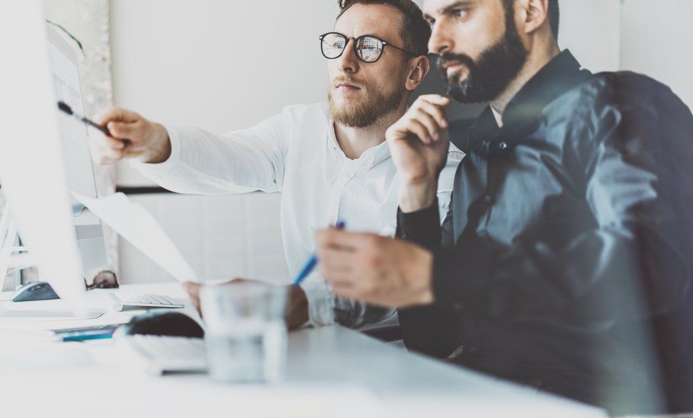 two man discussing something in a monitor