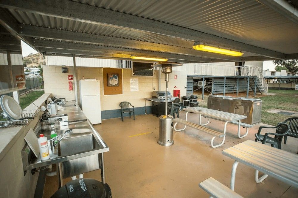 Outdoor Kitchen with Picnic Tables, Sink, Refrigerator, and Overhead Shelter — Leichhardt Accommodation in Mornington, QLD